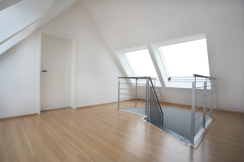 loft room with metal stairs and wooden floor
