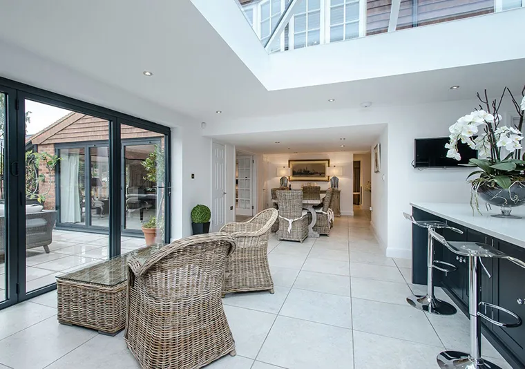 A living room filled with furniture and a large window.